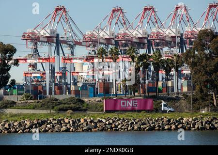 Long Beach, California, USA - July 24, 2023: Port container traffic leaves the Long Beach Container Terminal. Stock Photo