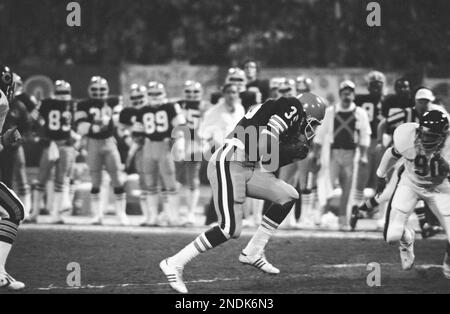 Cleveland Browns running back Calvin Hill, right, leaps to avoid the tackle  of Chicago Bears safety Lenny Walterscheid in the first quarter of game in  Cleveland, Nov. 3, 1980. Hill ran to