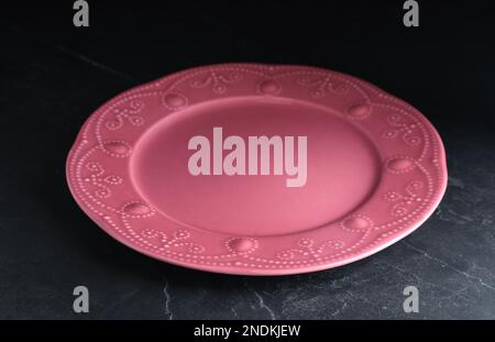 New clean plate on black slate table Stock Photo