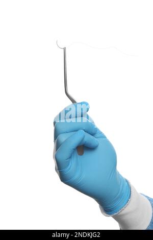 Doctor holding needle with suture thread on white background, closeup. Medical equipment Stock Photo