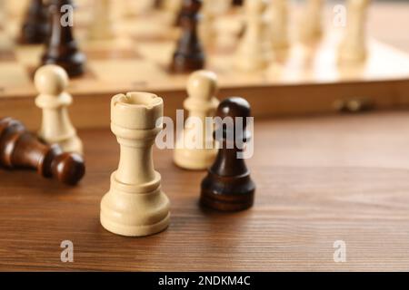 Closeup view of chess pieces on wooden table, space for text. Board game Stock Photo