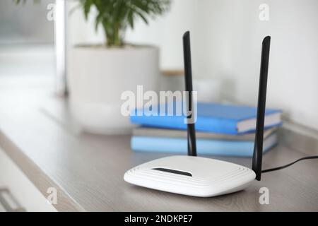 Modern Wi-Fi router indoors. Space for text Stock Photo