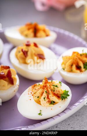 Deviled eggs with bacon and smoked paprika for Easter brunch Stock Photo