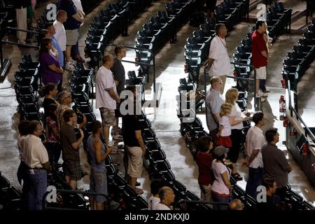 Members of the Colorado Rockies team stand at attention for the American  national anthem at a spring training major league baseball game at Salt  River Fields stadium in Scottsdale, Arizona - LOC's