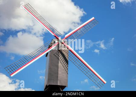 Rustic and iconic wooden windmill in idyllic Bruges public park, Belgium Stock Photo
