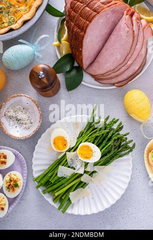 Asparagus cooked on a plate topped with parmesan cheese and soft boiled egg Stock Photo