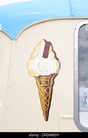 A hand painted graphic image of a 99 ice cream cone adorning a vintage Morris LD ice cream van at a steam rally and classic car event, July 2022. Stock Photo