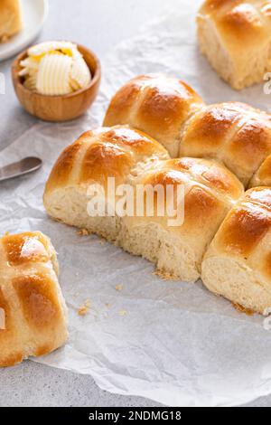 Traditional hot cross buns freshly baked for Easter brunch served with butter and orange marmalade Stock Photo