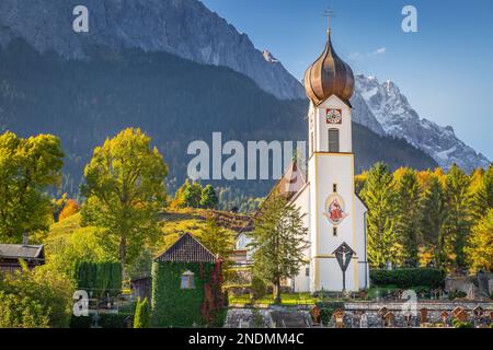 Grainau Church at golden autumn sunrise and Zugspitze massif, Bavarian alps , Germany Stock Photo