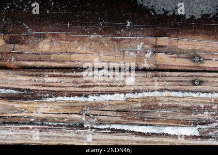 Close up view of a weathered wooden step in the sand of a beach Stock Photo