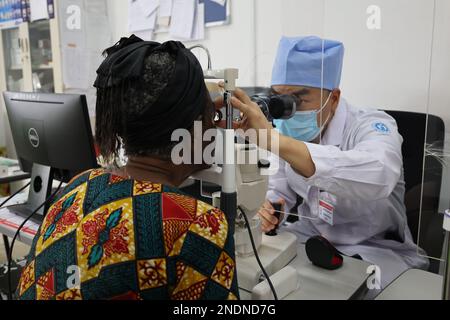 Accra, Ghana. 13th Feb, 2023. A Chinese doctor (R) from the Chinese medical team in Ghana checks a Ghanaian patient's eyes in LEKMA Hospital in Accra, the capital of Ghana, on Feb. 13, 2023. The Chinese medical team stationed at the LEKMA Hospital in Accra has offered free surgeries since last November to restore the vision of Ghanaians suffering from cataracts.TO GO WITH 'Feature: Chinese medical team helps Ghanaian patients restore sight' Credit: Seth/Xinhua/Alamy Live News Stock Photo