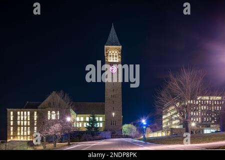 Ithaca, New York, US - February 14, 2023: Night photo of McGraw clock tower with clock face heart, a distinctive landmark in Cornell University. Stock Photo