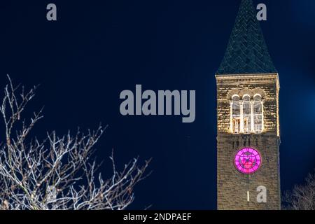 Ithaca, New York, US - February 14, 2023: Night photo of McGraw clock tower with clock face heart, a distinctive landmark in Cornell University. Stock Photo