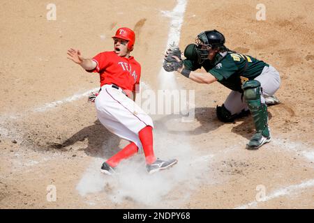 Texas Rangers' Ian Kinsler, left, slides past Washington Nationals