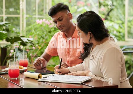 Diverse team of entrepreneurs working on business plan Stock Photo