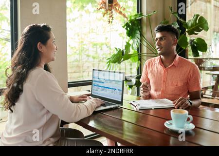 Business colleagues meeting in coffeeshop to discuss ideas for business development Stock Photo