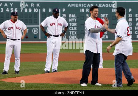 Boston Red Sox and former St. Louis Cardinals shortstop Edgar Renteria (L)  visits with old coaches Jose Oquendo (C) and Joe Pettini before a game at  Busch Stadium in St. Louis on