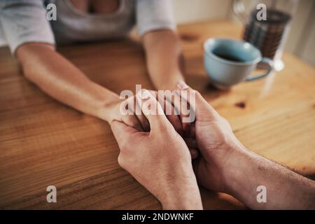 I want you to know that Im here for you. an unrecognizable couple holding hands. Stock Photo