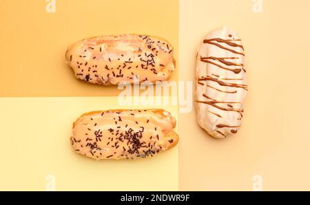 Tasty glazed eclairs on colorful background Stock Photo