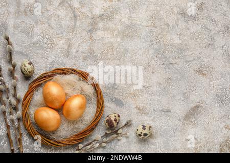 Wreath with Easter eggs and willow branches on grunge background Stock Photo