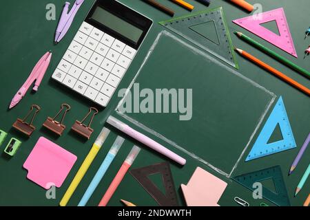 Frame made of different stationery on blackboard, closeup. Pi Day celebration Stock Photo