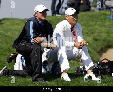 Anthony Kim of the United States, right, shares a light moment with