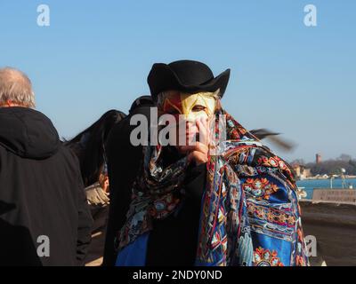 Venice, Italy - 13th february 2023 Carnival time and masked people gather in costume in Piazza San Marco area, Venezia. Stock Photo