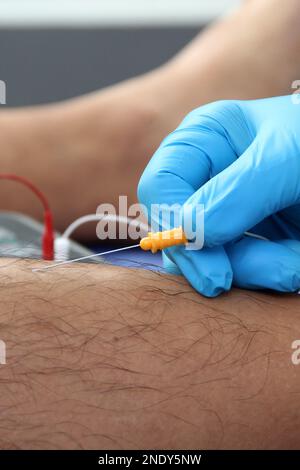 Electromyography in the lower limbs, graphic recording technique of the electrical activity produced by the tibial muscle performed by a specialist ne Stock Photo