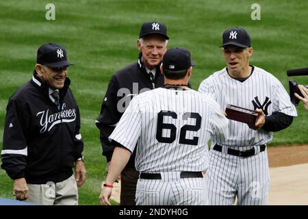 Joe Girardi, Yogi Berra and Whitey Ford watch New York Yankees Derek Jeter  receive his World Series championship ring before playing the Los Angeles  Angels of Anaheim on opening day at Yankee