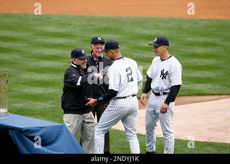 Joe Girardi, Yogi Berra and Whitey Ford watch New York Yankees Derek Jeter  receive his World Series championship ring before playing the Los Angeles  Angels of Anaheim on opening day at Yankee