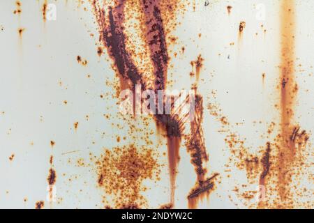 A rusty metal wall painted white. Rusty metal background with rust spots. Rusty metal texture background Stock Photo