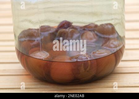 Enjoying Every Last Bit: Plum Compote in a Nearly Empty Jar Stock Photo