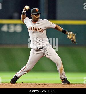 San Francisco Giants shortstop Edgar Renteria, center, helps turn a double  play as Philadelphia Phillies' Ben Francisco, right, is forced out at  second base during the first inning of a baseball game