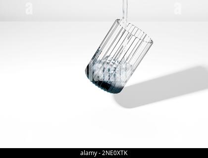 A 3d illustration of a Tilted ribbed glass with filling fresh water on a Levitating in the air Stock Photo