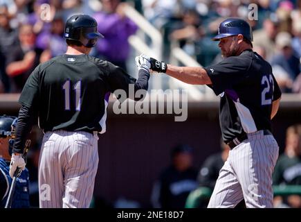 Colorado Rockies' Jason Giambi, left, is congratulated by teammate Troy  Tulowitzki after hitting a three-run home run off Kansas City Royals  starting pitcher Zack Greinke during third inning of a baseball game