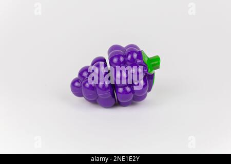 a plastic toy grapes on a white background Stock Photo