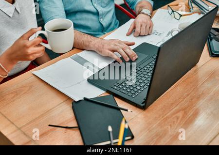 Coming together on a new project. Closeup shot of two architects working together on a laptop in an office. Stock Photo