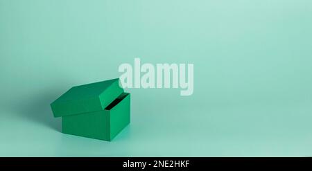 Green open gift box on a pink background. Gift on Valentine's Day, Women's Day, Stock Photo