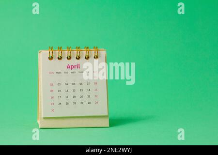 Hello April.Desktop calendar for April 2023 on the table Stock Photo