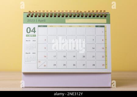 Hello April.Desktop calendar for April 2023 on the table Stock Photo