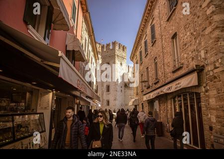 Sirmione, Italy 15 February 2023: A stunning view of the castle in Sirmione, Italy, surrounded by the beautiful blue waters of Lake Garda. The ancient Stock Photo