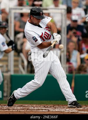 Minnesota Twins' J.J. Hardy hits a fly ball to left field in the sixth  inning of a baseball game against the Detroit Tigers Tuesday, April 27, 2010  in Detroit. Tigers' left fielder