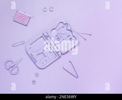 Toy sewing kit toned in lavender on a lavender background. Stock Photo