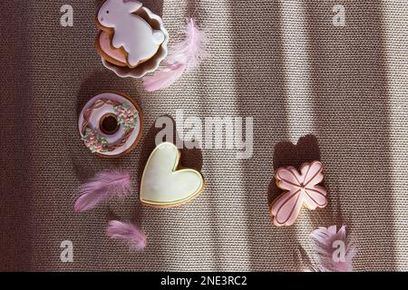 Easter trendy aesthetic with shadows background. Traditional glazing cookies. Easter food. Stock Photo