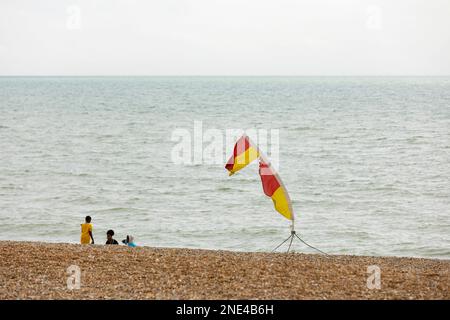 Hastings, united kingdom, 24, August 2022 Lifeguard flags blowing in sea breeze marking safe swimming area, Stock Photo