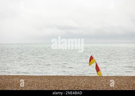 Hastings, united kingdom, 24, August 2022 Lifeguard flags blowing in sea breeze marking safe swimming area, Stock Photo
