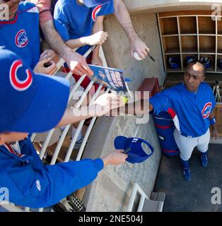 Chicago Cubs outfielder Alfonso Soriano signs autographs for fans