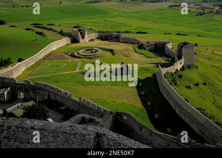 Fortress within a fortress: foundations of the mid-1400s round Jiskra Tower, named after mercenary commander John or Jan Jiskra and built as a separate stronghold, survive inside the walled outer bailey of Spiš Castle, a formidable fortress in the Košice Region of eastern Slovakia.  The castle, founded by Hungarian kings, became the largest fortified complex in Central Europe. Stock Photo