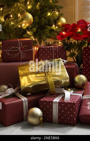 Many different gifts under Christmas tree indoors Stock Photo
