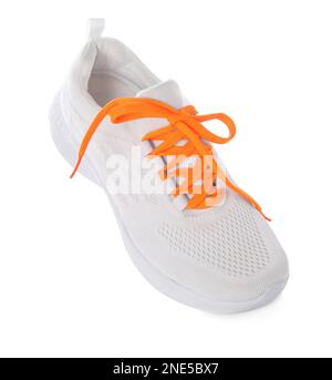 Stylish sneaker with orange shoelaces on white background Stock Photo